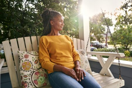 Woman sitting on front porch