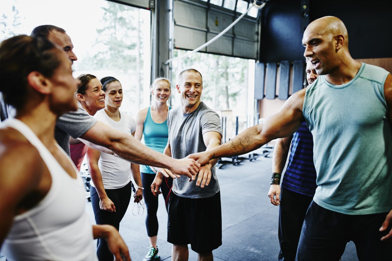 Group of friends celebrating together in gym